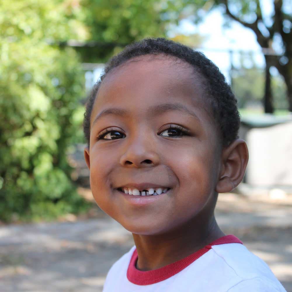 A child smiling at the center.