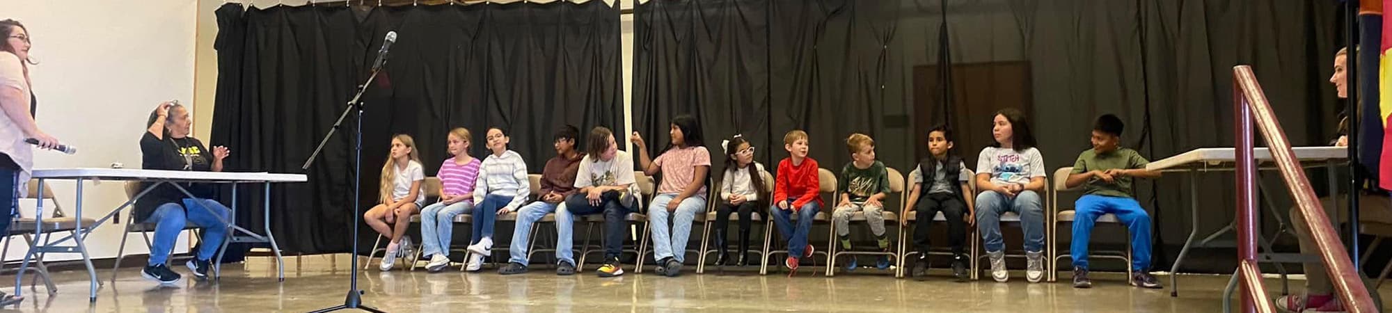 Students on stage for a spelling bee