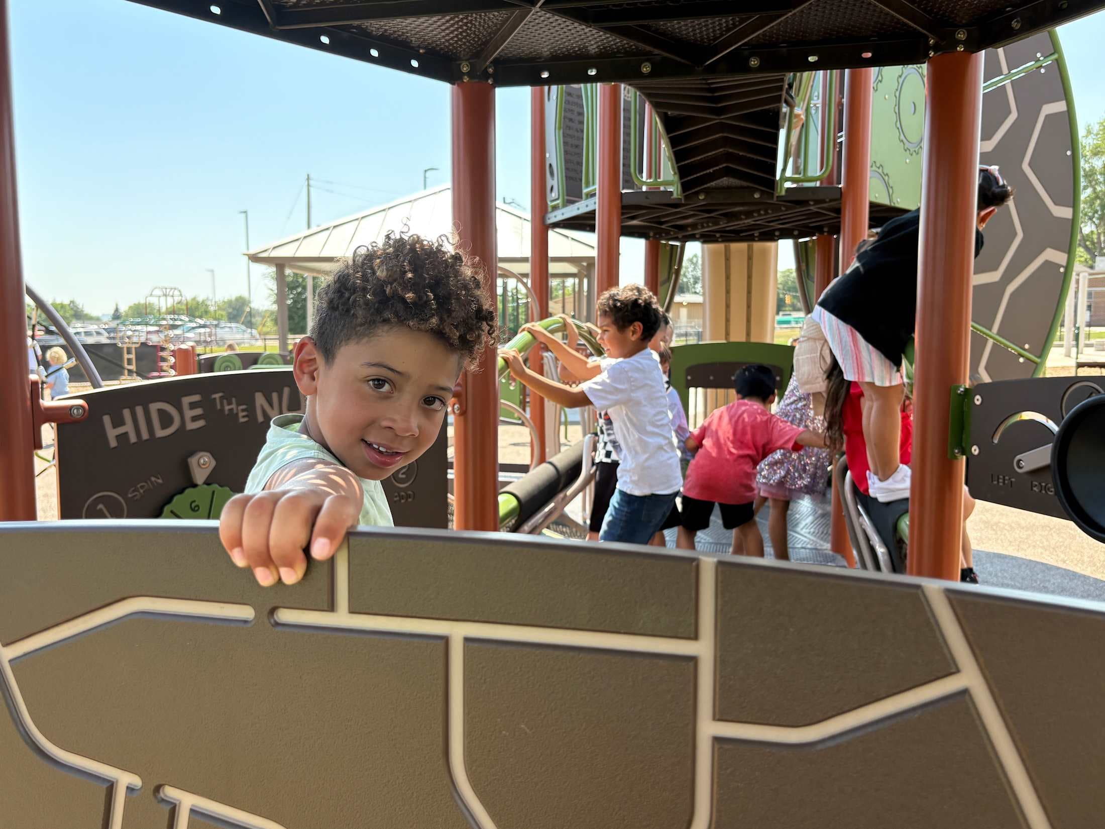 Student posing on the playground structure