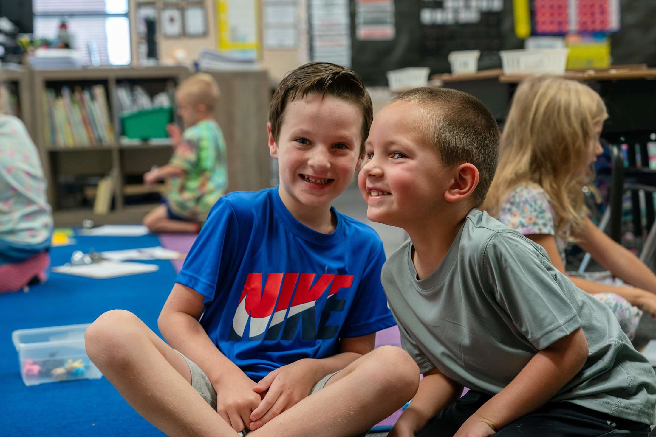 An image of two boys smiling at the camera.