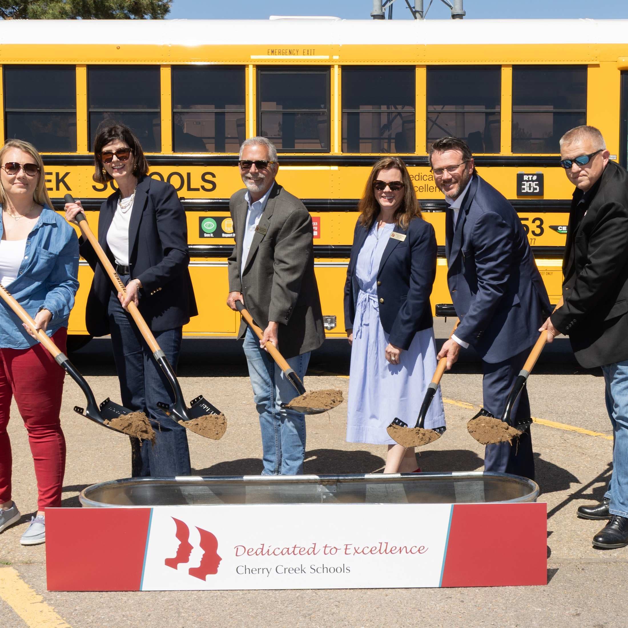six people with shovels at bus depot groundbreaking