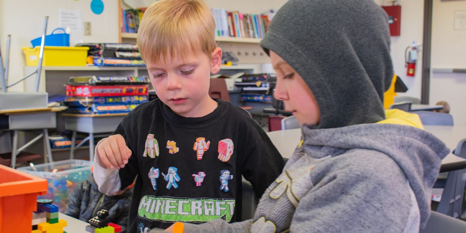 two boys constructing a lego set