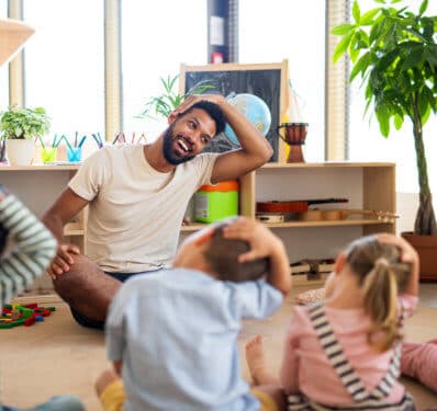 man showing demo exercise to kids