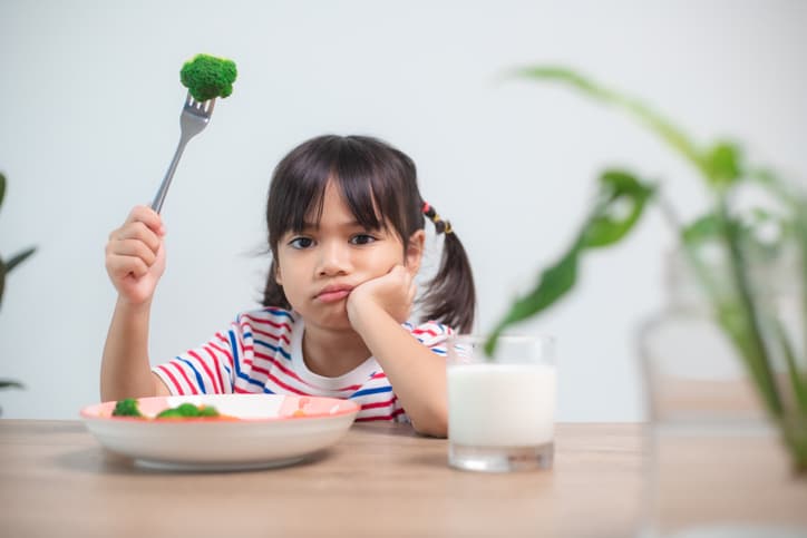 A child not wanting to eat their vegetables