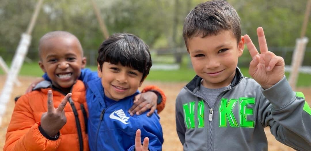 3 preschool boys on the playground at academy childcare center