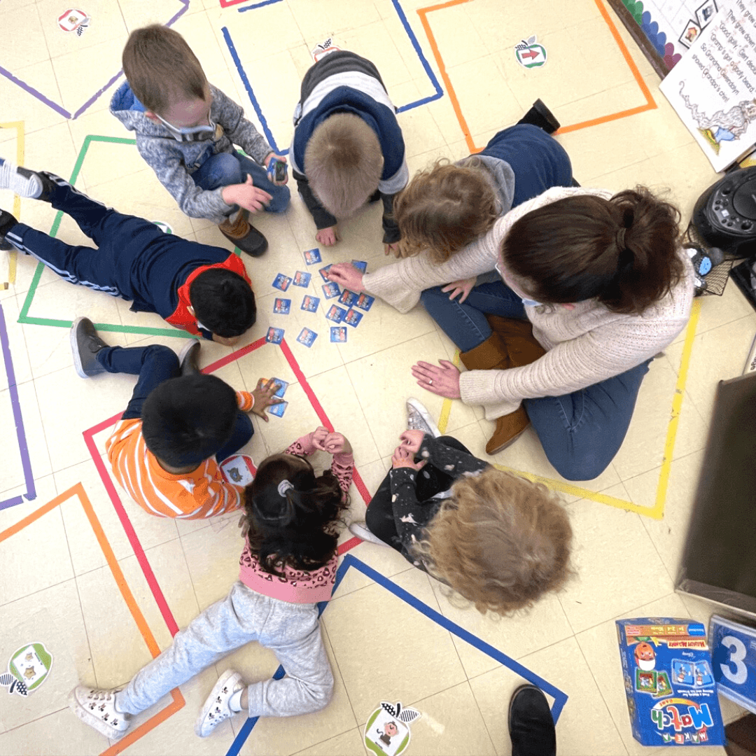 Miss Amanda plays a matching game with Head Start students.