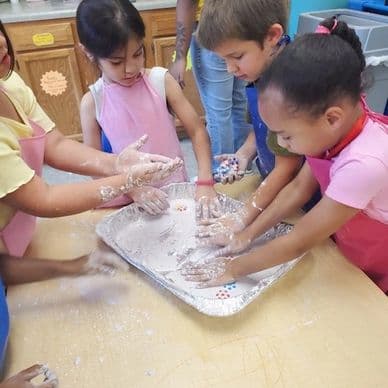 Group STEM activity showing children working together on a science project.