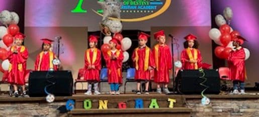 Graduation stage photograph associated with preschool graduates.